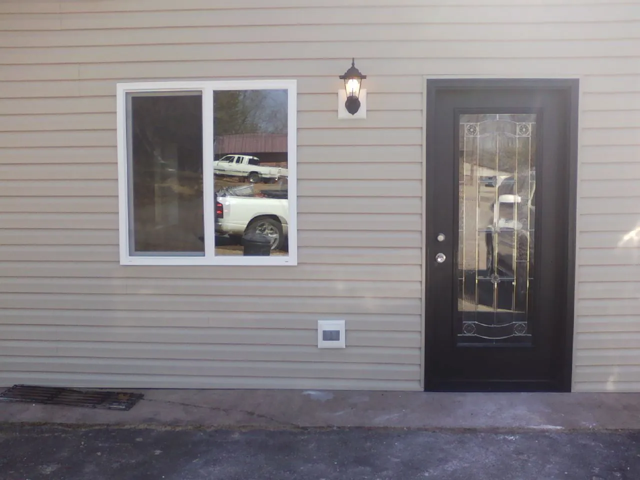 New siding, window and entry door on the side of an addition in Plainfield